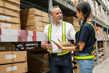 An old man talking in a warehouse
