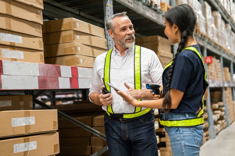 An old man talking in a warehouse