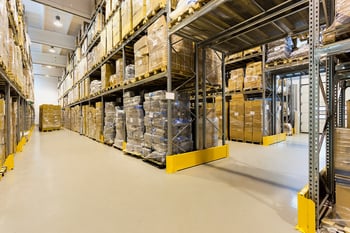 Interior of a huge spacious warehouse with carton boxes