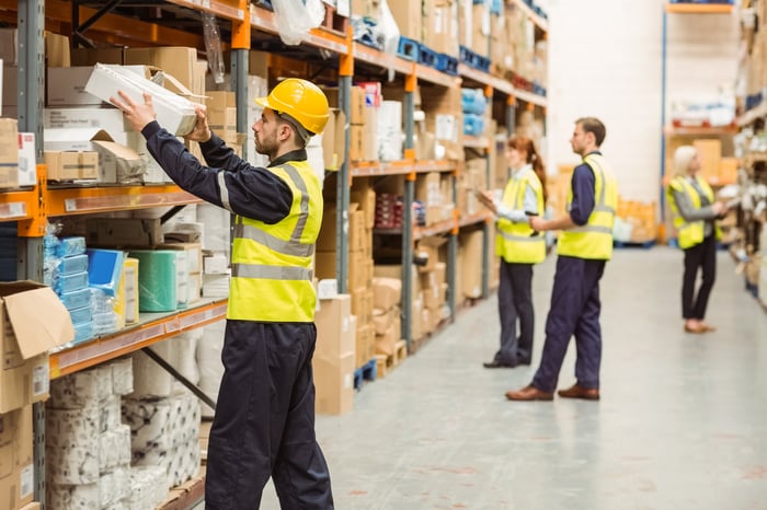 Warehouse worker taking package in the shelf in a large warehouse in a large warehouse-1