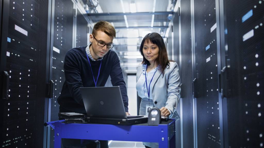 Two people working at a data center crash cart