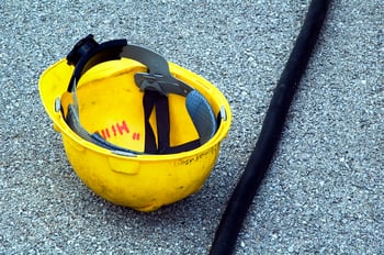 Yellow hardhat by cable on ground