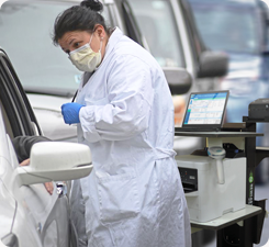 Woman working next to a Mobile Computer Workstation in a healthcare setting