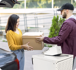 Worker handing customer a box