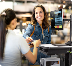 Retail worker assisting a customer on the retail floor with a mobile computer retail cart.