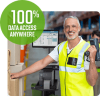 A smiling warehouse worker holding a scanner in one hand next to a mobile workstation.