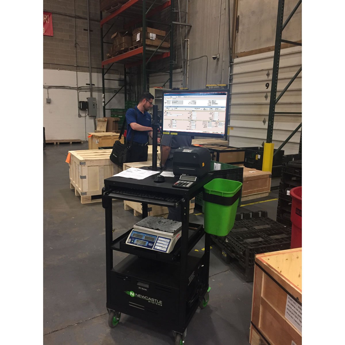 A Compact Mobile Computer Cart placed in the center of a warehouse