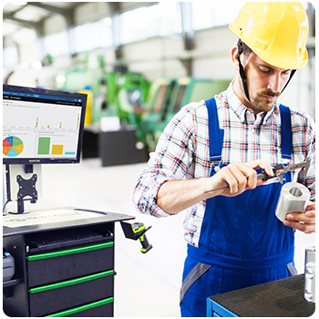 Worker doing something with tape next to a workstation